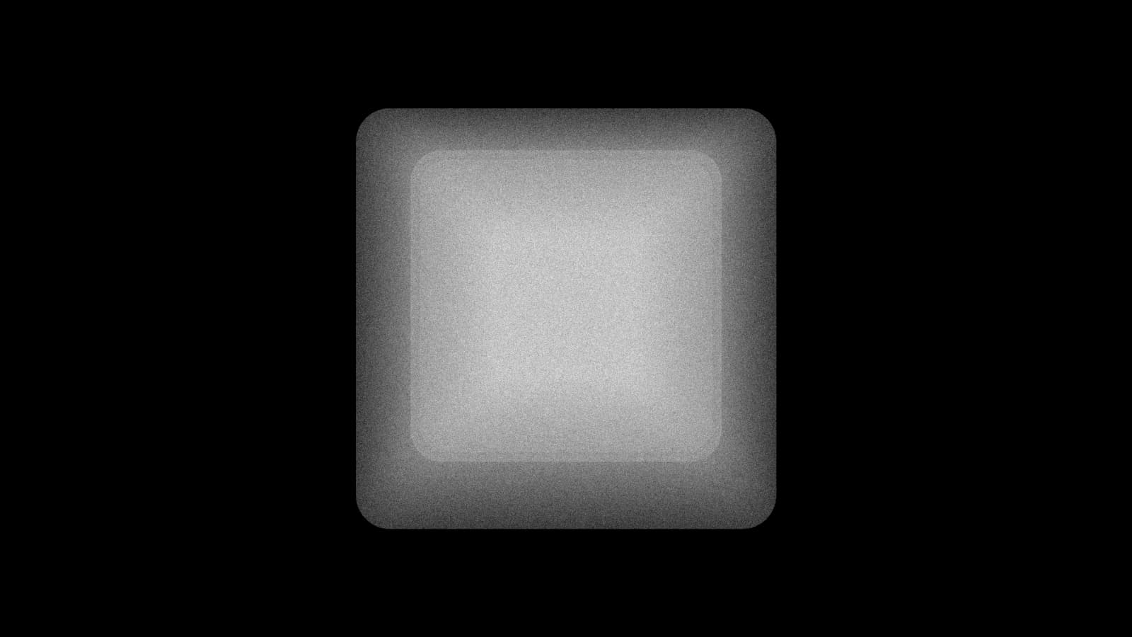 Illustration: a single blank keyboard keycap seen from above, a rounded square with a dished top and no letter on it, in black and white.